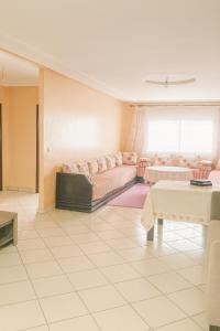 a living room with a couch and a table at Miss ALIA Aéroport in Tangier