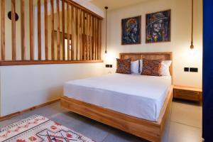 a bedroom with a bed and a staircase at Castle Residence by Aura Space in Paje