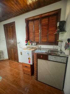a kitchen with a sink and a counter top at Morada do Sabiá - chalé 1 in Resende