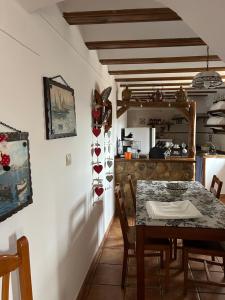 a dining room with a table and a kitchen at La Cueva in Vélez Blanco