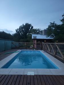 a large swimming pool on a wooden deck at Alma de Algarrobo in San Javier