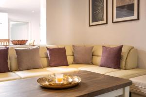 a living room with a couch with purple pillows at Ferienhaus "Hus Oetti" in Ostseebad Sellin +27 photos