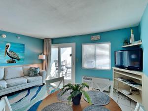 a living room with a couch and a table at Perdido Skye #54 in Perdido Key