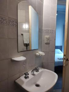 a bathroom with a sink and a mirror at Hostal Vampayá in Salta +105 photos