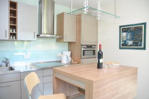 a kitchen with a wooden counter top with a bottle of wine at Ferienwohnung Malerwinkel in Seedorf