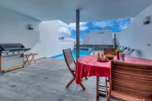 a kitchen with a table with a red table cloth at Villa Mariña- Heated pool in Playa Blanca
