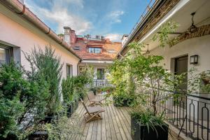 a courtyard with a bench on a wooden deck at ROOMA Apartments in Vilnius