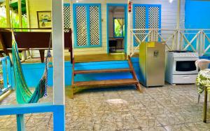 a house with a staircase and a kitchen with a stove at Ita Ita Casitas Playa Punta Uva in Punta Uva