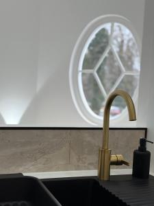 a kitchen counter with a sink and a window at Sublime logement neuf in Thaon-les-Vosges +17 photos