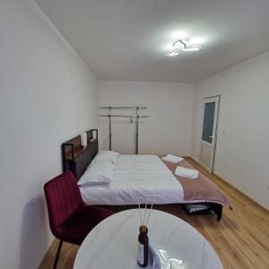 a bedroom with a bed and a table in it at Maria Central Studio in Târgu Neamț
