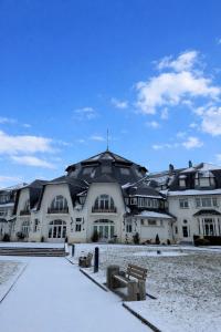 a large white building with a roof in the snow at Sublime logement neuf in Thaon-les-Vosges