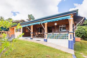 una piccola casa con tetto blu di Villa Sofaia à sainte-rose, 9 pers, 3 chambres, vue mer et montagne, piscine privée a Sainte-Rose