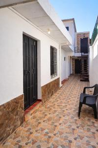 a hallway of a house with a black door and a chair at Casa Central de Santa Ana in Santa Ana +22 photos