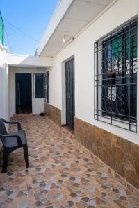 a house with a stone floor and a chair at Casa Central de Santa Ana in Santa Ana