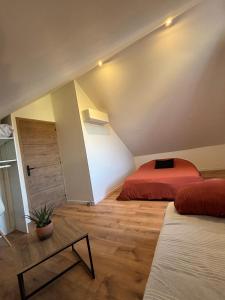 a attic room with two beds and a table at Ranteil in Albi