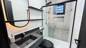 a bathroom with a sink and a shower at Mare Mansa Residence in Florianópolis +33 photos