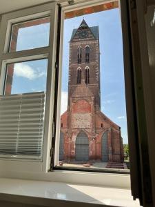 an open window with a view of a church at Marienkirche 1 - ABC335 in Wismar