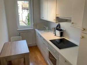 a kitchen with white cabinets and a counter top at Marienkirche 1 - ABC335 in Wismar
