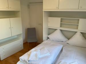 a bedroom with a bed with towels on it at Marienkirche 1 - ABC335 in Wismar +17 photos