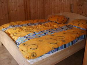 a bed with a teddy bear blanket on it at Hütta Monika in Sankt Gallenkirch