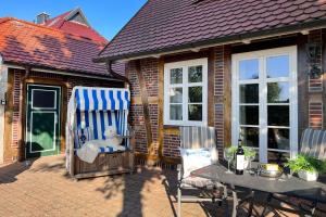 a teddy bear sitting in a rocking chair on a patio at Wellnessoase in Prerow