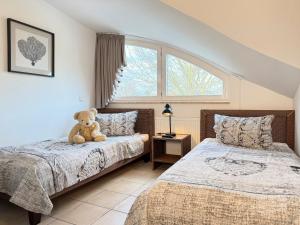 a teddy bear sitting on a bed in a bedroom at Wellnessoase in Prerow