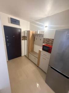 a small kitchen with a refrigerator and a stove at Studio Maria in Galaţi