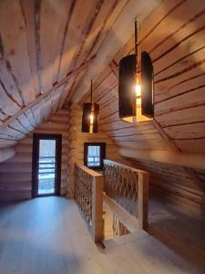 a room in a log cabin with two lights at Rooslepa puhkemaja in Tuksi