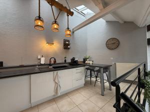 a kitchen with a sink and a counter top at Loft Des Sens in Saint-Chamond