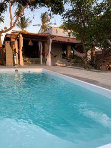 a large blue swimming pool in front of a house at Amaro Residence in Santo Amaro
