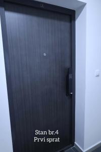 een zwarte deur met de woorden stan der pyru spam erop bij Splendid J&R apartman in Bijeljina +30 foto's