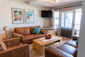 a living room with a couch and a table at Dookes Apartment in Umdloti