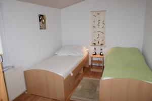 a small bedroom with a bed and a green rug at Ferienhaus Thiess - ABC402 in Wismar