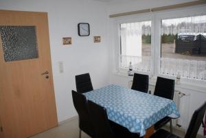a dining room with a table and chairs and a window at Ferienhaus Thiess - ABC402 in Wismar