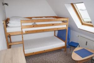 a bedroom with two bunk beds in a room at Ferienhaus Thiess - ABC402 in Wismar +8 photos