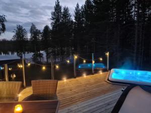a deck with a swimming pool and a hot tub at Villa lehto in Kuusamo