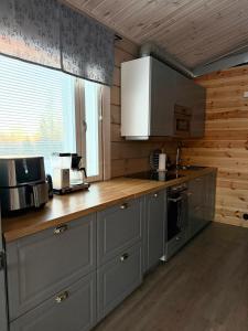a kitchen with gray cabinets and a counter top at Honkamaja, Aavasaksa, Lappi, Lapland in Aavasaksa +31 photos