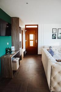 a living room with a couch and a table at Pine apartment Vlašić in Vlasic