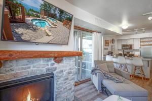 a living room with a fireplace and a tv at Rimfire 342: Memory Maker, Walk to Shops, Slope Side in Slaty Fork +28 photos