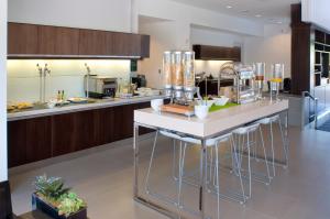 a kitchen with a counter with stools in it at Element by Marriott Vaughan Southwest in Vaughan