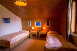a room with two beds and two night stands at Haus Framgard in Zirkitzen