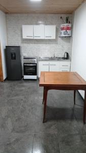 a kitchen with a wooden table and a stove at Belén in Mar del Plata