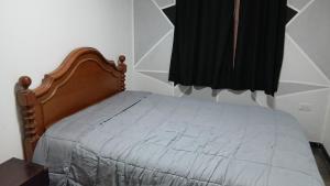a small bed in a room with a window at Belén in Mar del Plata