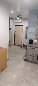 an empty room with a large door in a room at Aкварель на Черемушках in Odesa