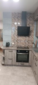 a kitchen with a counter with a stove top oven at Aкварель на Черемушках in Odesa