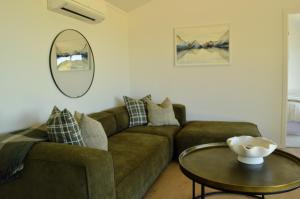 a living room with a couch and a table at Tihi in Otorohanga