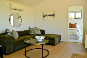 a living room with a couch and a table at Tihi in Otorohanga