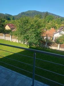 a fence in front of a field of grass at MONADIN Villa Relax & Spa in Săcele +205 photos