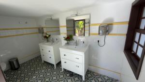 a bathroom with two sinks and a mirror at Almabella in Breña Baja