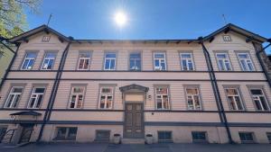 a large wooden building with a brown door at Bohemian Chic apartment in Kalamaja in Tallinn